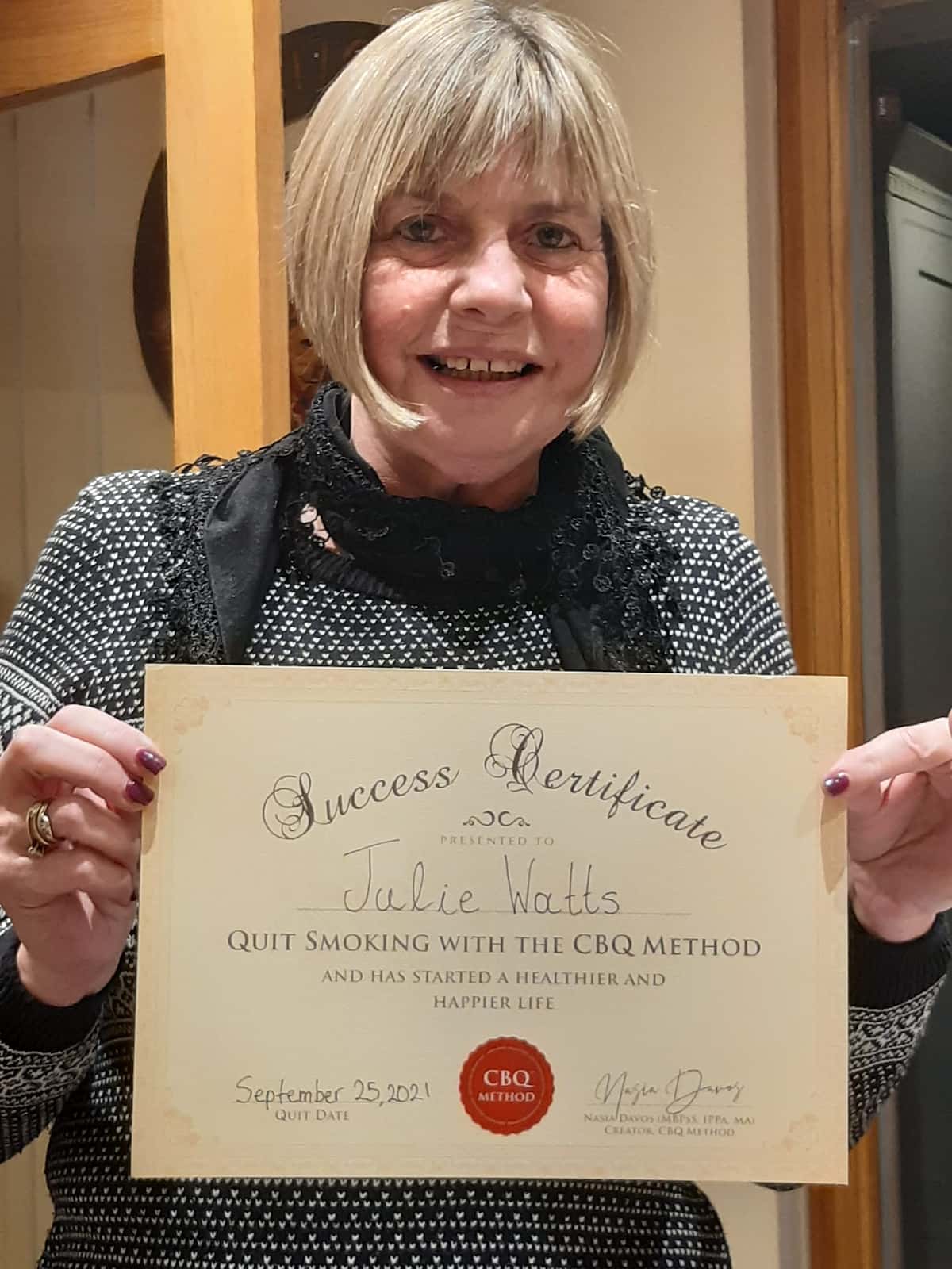 CBQ Nicotine Freedom Program member Julie Watts holding her CBQ Freedom Certificate