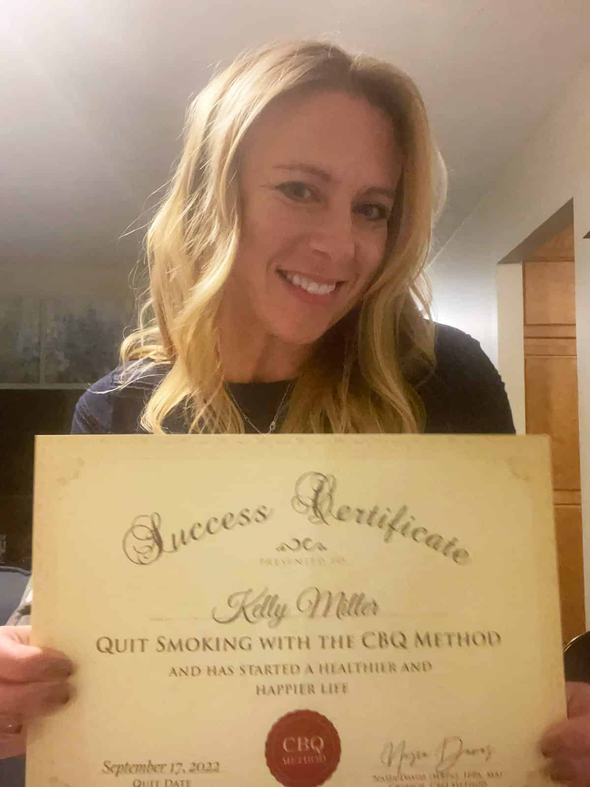 CBQ Nicotine Freedom Program member Kelly Miller holding her CBQ Freedom Certificate