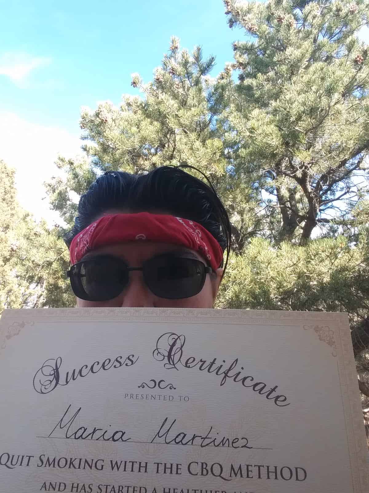 CBQ Nicotine Freedom Program member Maria Martinez holding her CBQ Freedom Certificate