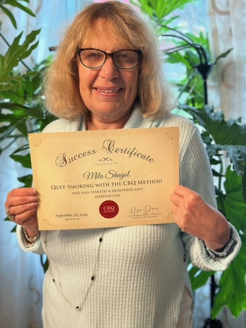 CBQ Nicotine Freedom Program member Mila Shugol holding her CBQ Freedom Certificate
