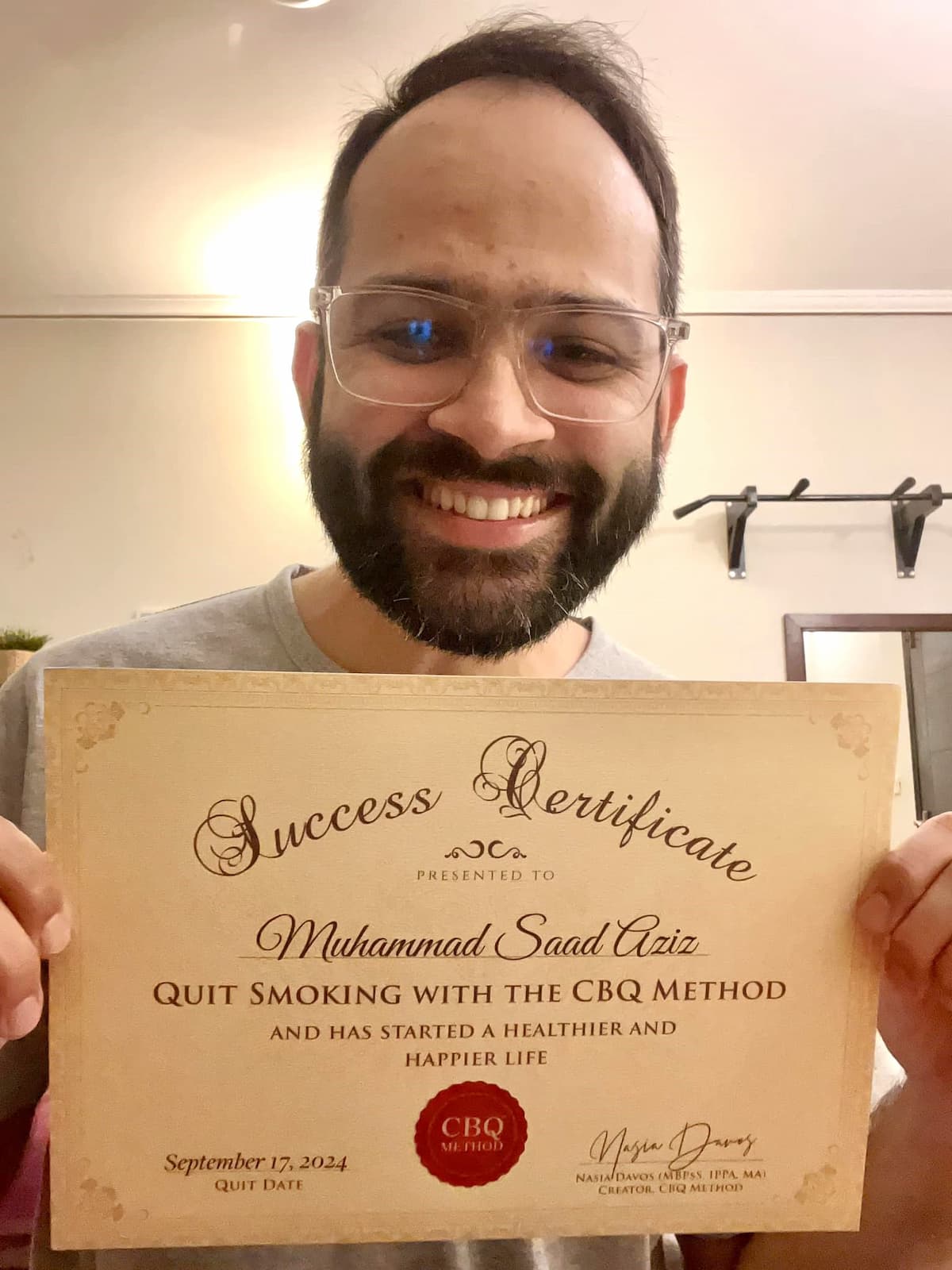 CBQ Nicotine Freedom Program member Saad Aziz holding his CBQ Freedom Certificate