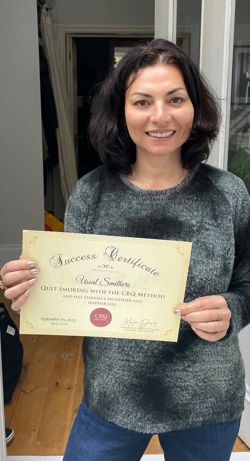 CBQ Nicotine Freedom Program member Ussal Smithers holding her CBQ Freedom Certificate