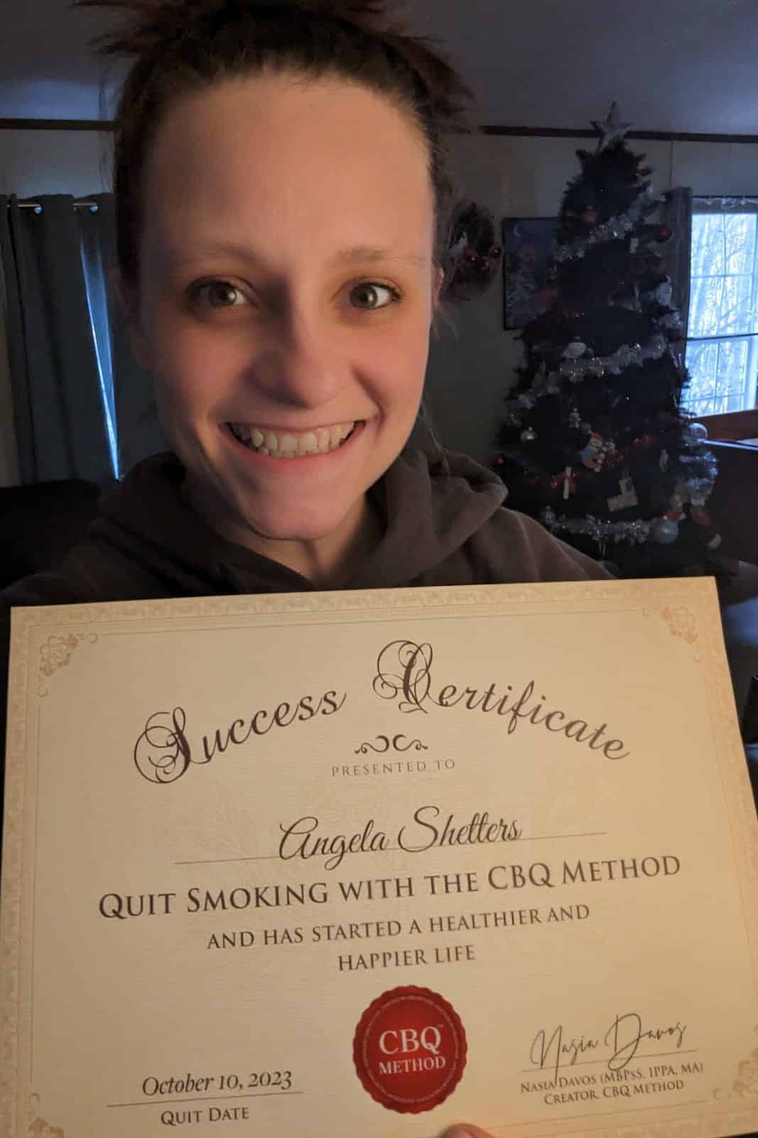 CBQ Nicotine Freedom Program member Angela Shetters holding her CBQ Freedom Certificate