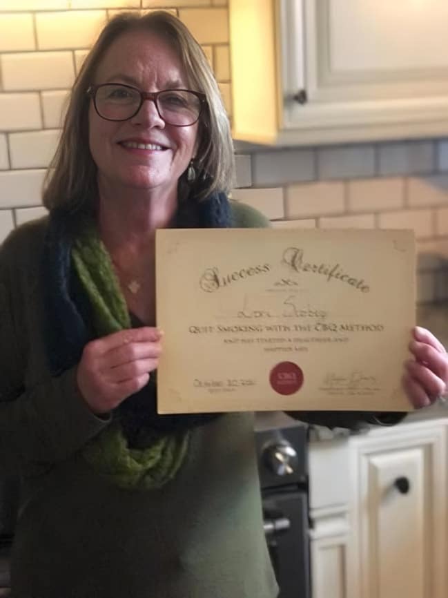 CBQ Nicotine Freedom Program member Lori Scobey holding her CBQ Freedom Certificate