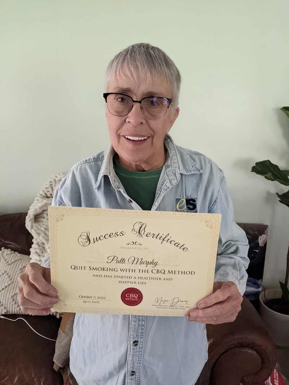 CBQ Nicotine Freedom Program member Patti Murphy holding her CBQ Freedom Certificate